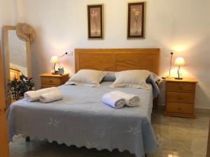 a bedroom with a bed with towels on it at Casa Los Hortets in Deltebre +37 photos