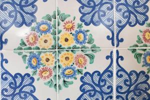 a blue and white tile wall with flowers on it at Amalfi Old Square room & apartments in Amalfi