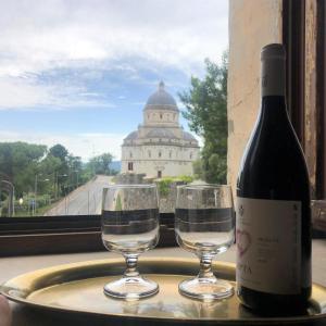 a bottle of wine and two glasses on a tray at Torre Caetani- Night in a medieval tower in Todi