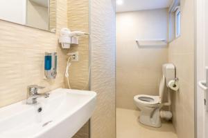 a bathroom with a sink and a toilet at Vila Jun in Eforie Nord