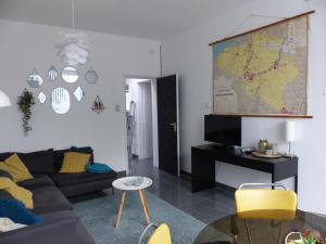 a living room with a couch and a map on the wall at Flandriens in Bredene
