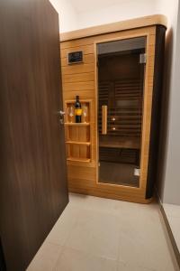 a door leading into a kitchen with a microwave at Resita Residence Sauna Apartment in Reşiţa