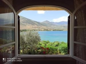 a window view of a lake from a house at Aphrodite's Coast Retreat House! in Galaxidi