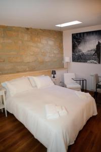 a bedroom with a white bed with two towels on it at B&B Thule in Caltanissetta