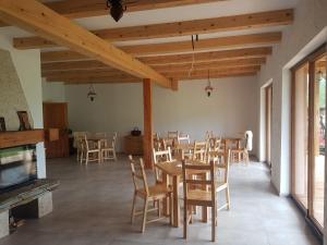 a dining room with wooden tables and chairs at Michniowiec 6 in Czarna