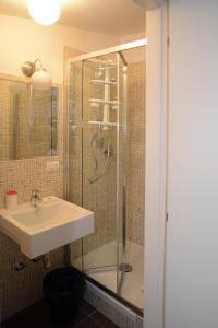 a bathroom with a sink and a shower at B&B Thule in Caltanissetta