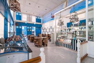 a restaurant with blue walls and tables and chairs at My Resort HuaHin D612 by Lux9 in Hua Hin