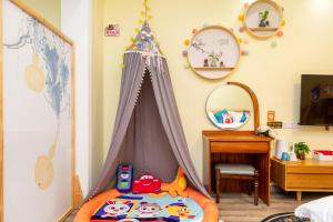 a childs bedroom with a bed with a play tent at Nancy Guesthouse in Shanghai