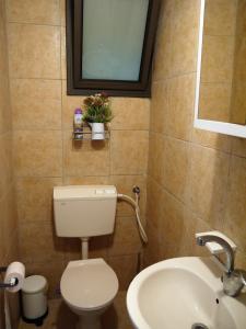 a bathroom with a toilet and a sink at art room in Midrakh ‘Oz