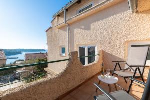 a balcony with chairs and a view of the water at Horizont view apartment in Pula