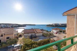 a view of the water from the balcony of a building at Horizont view apartment in Pula