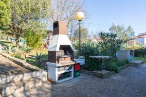 a barbecue grill sitting on a sidewalk next to a street light at Horizont view apartment in Pula