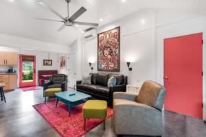 a living room with a couch and a table at Folly Vacation 209 East, Modern, Sassy and 3 Blocks to the Beach in Folly Beach
