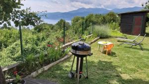 a grill in the yard of a garden with a table at Apartments Turan in Rijeka