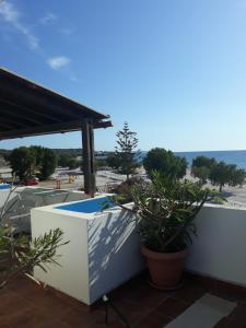 a balcony with a view of the beach at Katerina & Efi Apartments in Mastichari