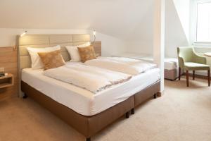 Ein Bett oder Betten in einem Zimmer der Unterkunft Ferienpension Seeblick