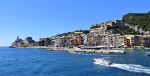 a boat in the water in front of a city at Punti di Vista in Portovenere