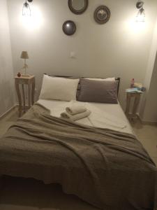 a bedroom with a bed with two towels on it at DORA'S APARTMENTS STUDIO 1 in Corfu +16 photos