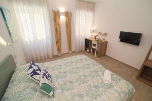 a bedroom with a large bed and a television at B&B CASA GIOVANNA in Campese