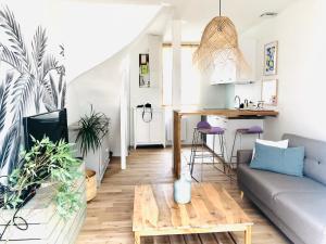 a living room with a couch and a table at Maison BB Burgonce Bohème centre avec extérieur WIFI gratuit et NETFLIX in Niort