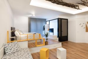 a living room with a bed and a couch at Suite Nest in Padrón