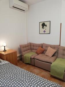 a living room with a couch and a bed at Apartments Mare Losinjska 16 in Rabac