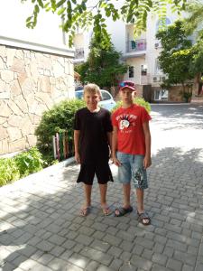 a man and a woman standing on a sidewalk at Apart-hotel Argo in Koktebel