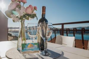 a table with a bottle of wine and two glasses at Blaise in Trogir