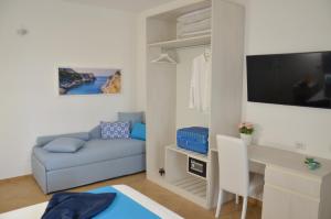 a small living room with a couch and a desk at Sorrento Maison Lurò in Sorrento