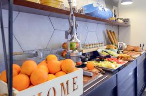 a bunch of oranges on a counter in a kitchen at Paamonim Hotel Jerusalem in Jerusalem