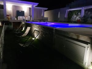 a swimming pool at night with blue lights at Stella Marina Agropoli in Agropoli