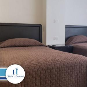 Postel nebo postele na pokoji v ubytování Hotel Imperial