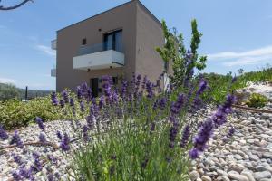 a house with purple flowers in front of it at View Villas Collection in Vinišće