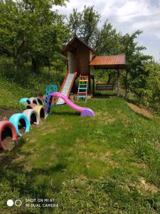 a playground with a slide and a gazebo at Kray Dorogy in Yaremche