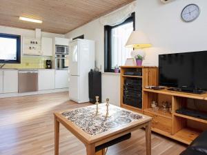 a living room with a tv and a coffee table at 6 person holiday home in Gedser in Gedser