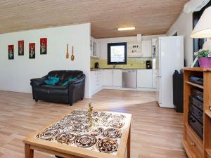 a living room with a couch a table and a kitchen at 6 person holiday home in Gedser in Gedser