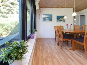 a dining room with a table and chairs at 6 person holiday home in Gedser in Gedser