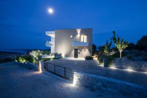 a house with lights on the side of a driveway at View Villas Collection in Vinišće