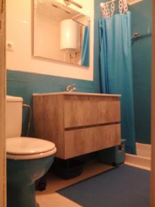 a bathroom with a sink and a toilet and a mirror at Paradis in Morro del Jable