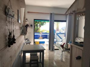 a kitchen with a table and a view of a patio at Paradis in Morro del Jable