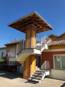 a building with a balcony and stairs on it at La Siesta Bed&Residence in Cardano al Campo
