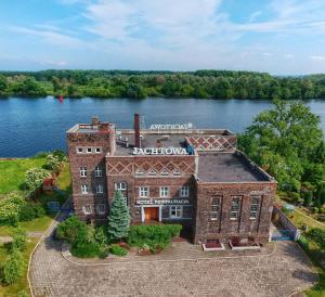 an aerial view of an old brick building on the water at JACHTOWA Hotel i Restauracja in Szczecin