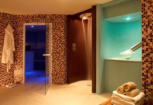 a bathroom with a shower with a glass door at Feversham Arms Hotel & Verbena Spa in Helmsley +38 photos