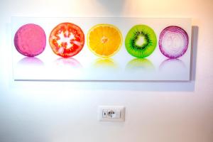 a wall with four different types of fruit on it at Casa Bianca Rais Gerbi in Finale