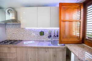 a kitchen with a sink and a stove top oven at Casa Bianca Rais Gerbi in Finale +37 photos
