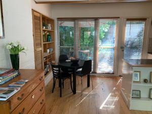 a kitchen with a table and chairs in a room at Garden Cottage St Kilda in Melbourne