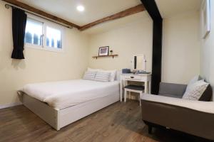 A bed or beds in a room at Just4u Guesthouse