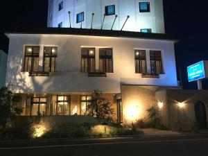 a white building on a street at night at Hyuga Dai-ichi Hotel in Hyuga