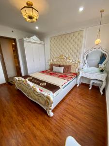 a bedroom with a large bed and two chairs at SHP Plaza Khanh Phong Homestay in Hai Phong