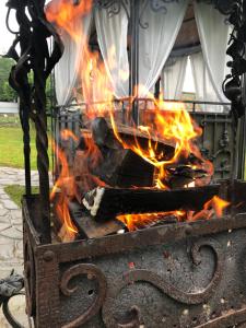 a fire in a stone grill with flames at Garage in Yaremche